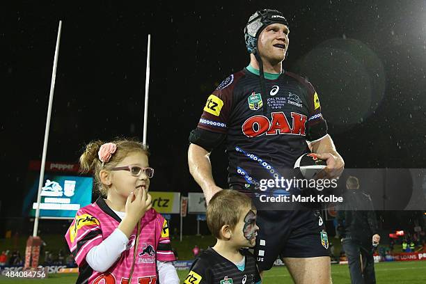 Nigel Plum of the Panthers celebrates with his family after playing his 150th NRL match during the round 23 NRL match between the Penrith Panthers...