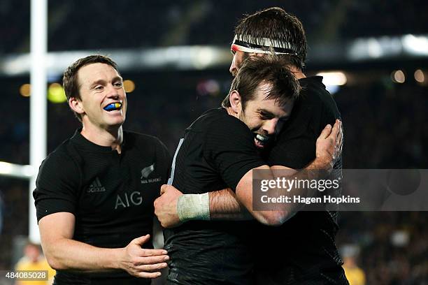 Conrad Smith of the All Blacks celebrates his try with teammates Ben Smith and Samuel Whitelock during The Rugby Championship, Bledisloe Cup match...