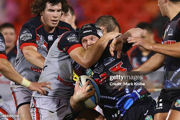 Nigel Plum of the Panthers is tackled during the round 23 NRL match between the Penrith Panthers and the New Zealand Warriors at Pepper Stadium on...