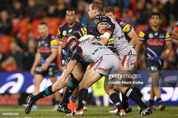 Nigel Plum of the Panthers is tackled during the round 23 NRL match between the Penrith Panthers and the New Zealand Warriors at Pepper Stadium on...