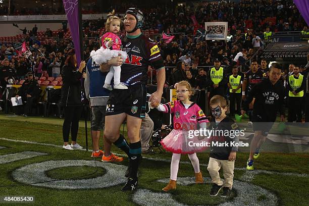 Nigel Plum of the Panthers takes the field with his children during the round 23 NRL match between the Penrith Panthers and the New Zealand Warriors...