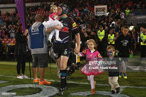 Nigel Plum of the Panthers takes the field with his children during the round 23 NRL match between the Penrith Panthers and the New Zealand Warriors...