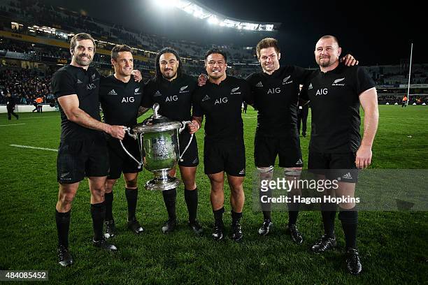 To R, Conrad Smith, Daniel Carter, Ma'a Nonu, Keven Mealamu, Richie McCaw and Tony Woodcock of the All Blacks pose with the Bledisloe Cup during The...