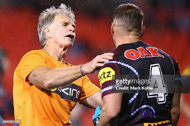 Head trainer of the Penrith Panthers Ronnie Palmer treats Lewis Brown of the Panthers during the round 23 NRL match between the Penrith Panthers and...