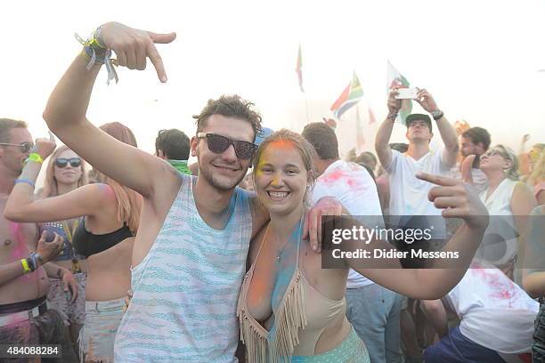 Festival goers pose for a photogaph after they have participated in the color party, a cavalcade of tons of color powder at Sziget festival at Obudai...