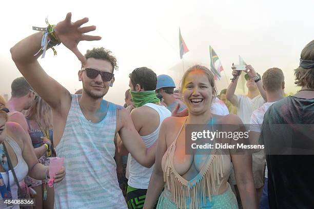 Festival goers pose for a photogaph after they have participated in the color party, a cavalcade of tons of color powder at Sziget festival at Obudai...