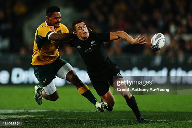 Daniel Carter of New Zealand offloads in the tackle from Henry Speight of Australia during The Rugby Championship, Bledisloe Cup match between the...