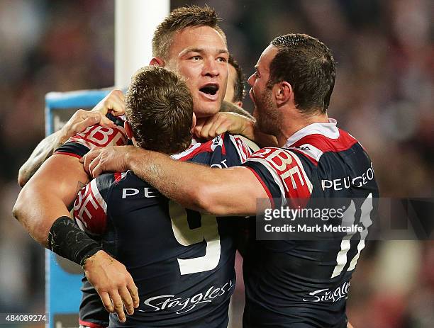 Jared Waerea-Hargreaves of the Roosters celebrates scoring a try with team mates Jake Friend and Boyd Cordner during the round 23 NRL match between...