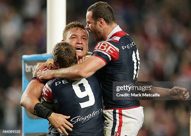 Jared Waerea-Hargreaves of the Roosters celebrates scoring a try with team mates Jake Friend and Boyd Cordner during the round 23 NRL match between...