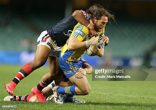 Tepai Moeroa of the Eels is tackled during the round 23 NRL match between the Sydney Roosters and the Parramatta Eels at Allianz Stadium on August...