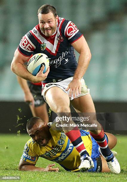 Boyd Cordner of the Roosters breaks a tackle during the round 23 NRL match between the Sydney Roosters and the Parramatta Eels at Allianz Stadium on...