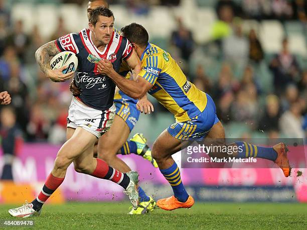 Mitchell Pearce of the Roosters is tackled during the round 23 NRL match between the Sydney Roosters and the Parramatta Eels at Allianz Stadium on...