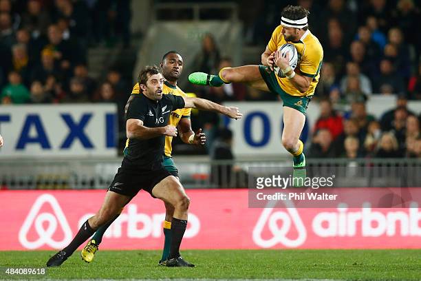 Adam Ashley-Cooper of the Wallabies takes a high ball under pressure from Conrad Smith of the All Blacks during The Rugby Championship, Bledisloe Cup...