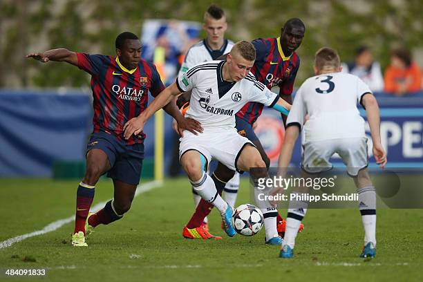 Felix Platte of FC Schalke 04 competes for the ball with Adama Traore and Elohor Godswill during the UEFA Youth League Semi Final match between...