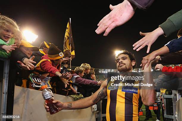 Cyril Rioli of the Hawks celebrates the win with fans during the round 20 AFL match between the Geelong Cats and the Hawthorn Hawks at Melbourne...