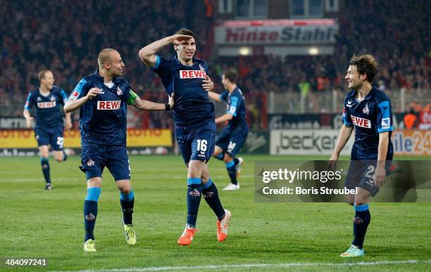 Patrick Helmes of Koeln celebrates after scoring his team's second goal by free-kick with team mates during the Second Bundesliga match between 1.FC...