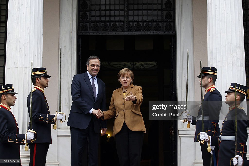 Angela Merkel Visits Athens As Greek Bonds Go Back On Sale