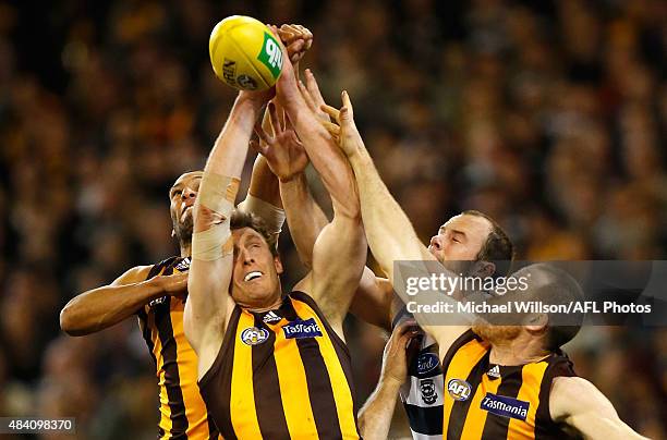 Josh Gibson and Ben McEvoy of the Hawks, Josh Walker of the Cats and Jarryd Roughead of the Hawks compete for the ball during the 2015 AFL round 20...