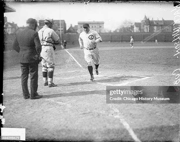 Baseball player Hack Wilson of the National League's Chicago Cubs, crossing home plate during a game at Wrigley Field, Chicago, Illinois, 1930. An...