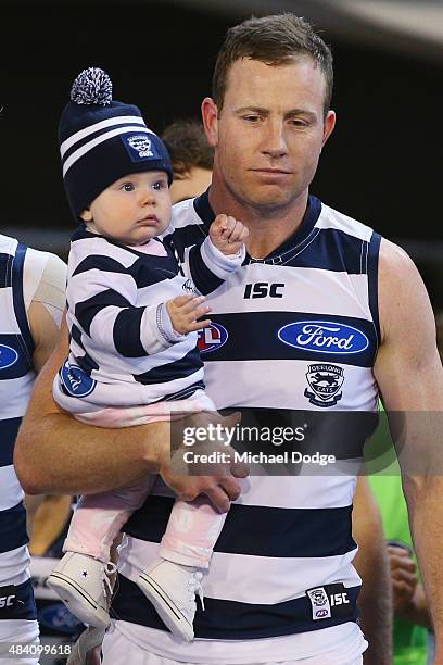 Steve Johnson of the Cats walks out for his 250th game with his kids during the round 20 AFL match between the Geelong Cats and the Hawthorn Hawks at...