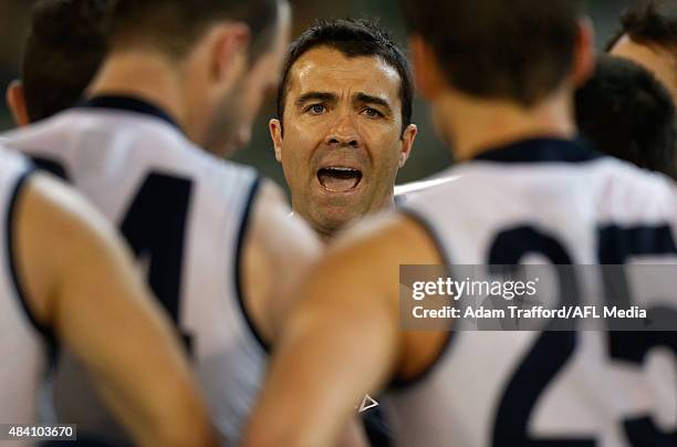 Chris Scott, Senior Coach of the Cats addresses his players during the 2015 AFL round 20 match between the Geelong Cats and the Hawthorn Hawks at the...