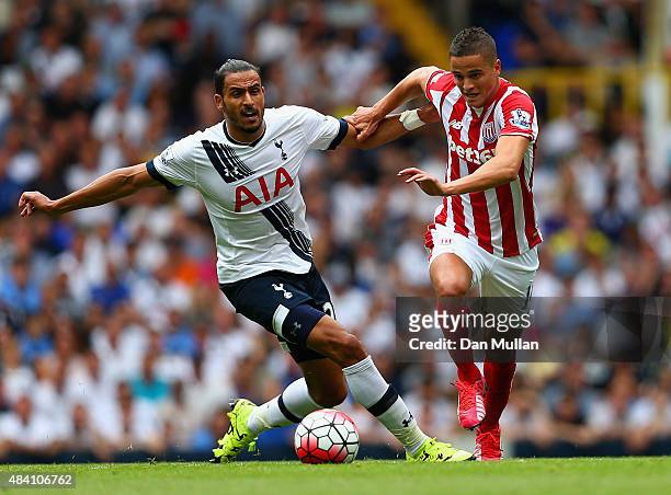 Ibrahim Afellay of Stoke City and Nacer Chadli of Tottenham Hotspur compete for the ball during the Barclays Premier League match between Tottenham...