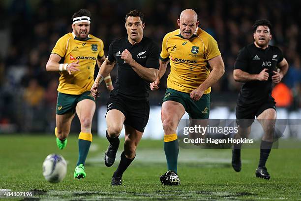 Daniel Carter of the All Blacks chases down a loose ball under pressure from Stephen Moore of the Wallabies during The Rugby Championship, Bledisloe...