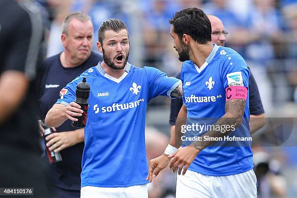 Marcel Heller of Darmstadt reacts with Aytac Sulu during the Bundesliga match between SV Darmstadt 98 and Hannover 96 at Merck-Stadion am...