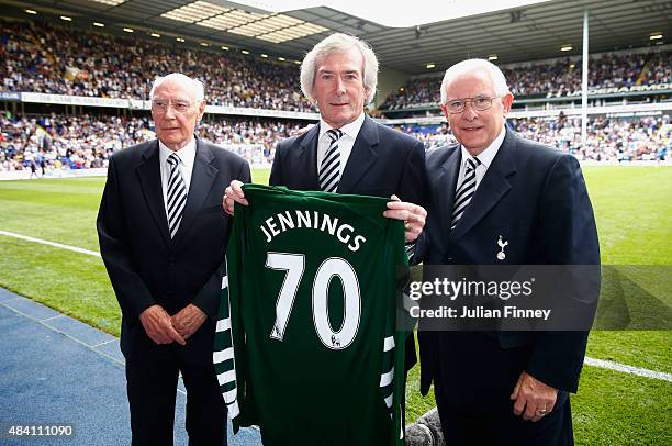 Ex-Spurs goalkeeper Pat Jennings is presented with a shirt to mark his 70th birthday by Alan Gilzean and Alan Mullery during the Barclays Premier...