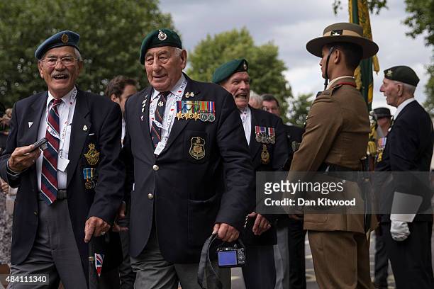 Veterans process down Whitehall past a statue of Field Marshall Slim during the 70th Anniversary commemorations of VJ Day on August 15, 2015 in...
