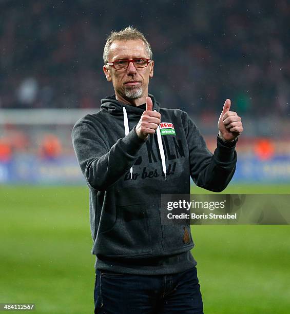 Peter Stoeger, head coach of Koeln celebrates with his fans after winning the Second Bundesliga match between 1.FC Union Berlin and 1. FC Koeln at...