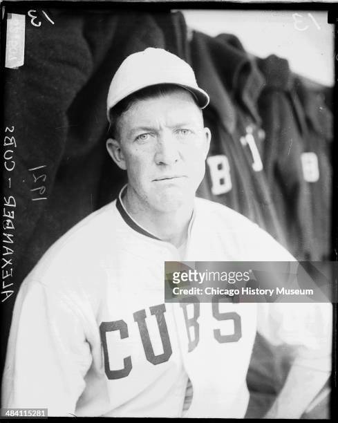 Chicago Cubs baseball player Grover Cleveland Alexander sitting in a dugout at Weeghman Park, Chicago, Illinois, 1921. Weeghman Park was renamed...