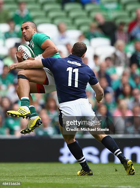 Simon Zebo of Ireland claims a high ball as Tim Visser of Scotland closes in during the International match between Ireland and Scotland at the Aviva...