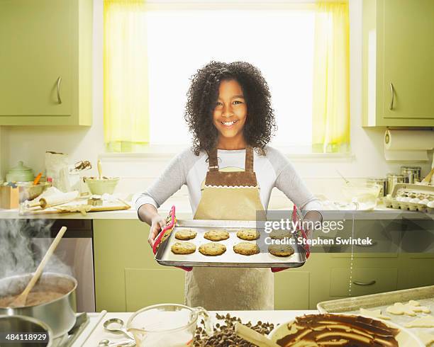 9 year old girl posing with baked cookies - old person kitchen food ストックフォトと画像