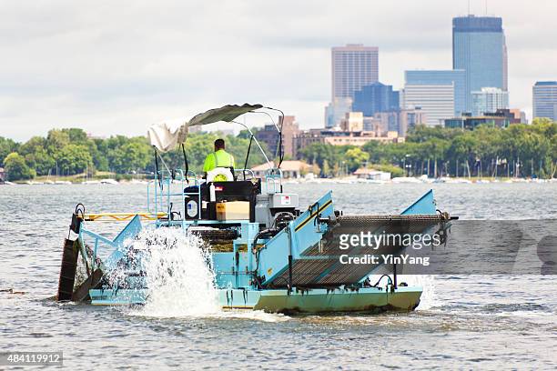 weed cutter working in city lake removing aquatic weeds - introduced species stock pictures, royalty-free photos & images
