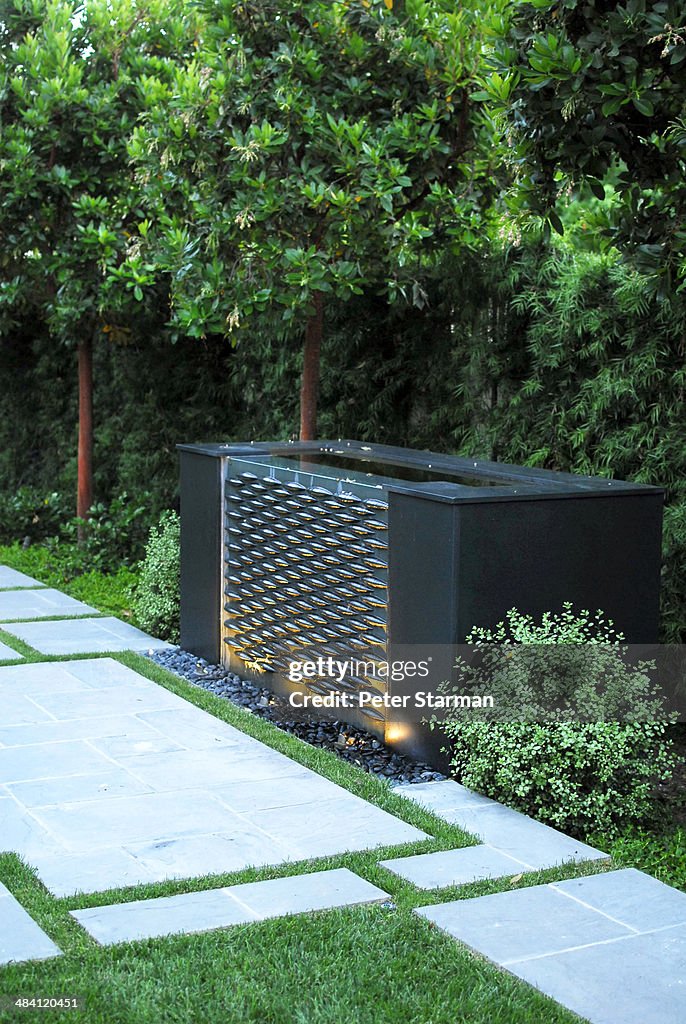 Water fountain in modern back yard.