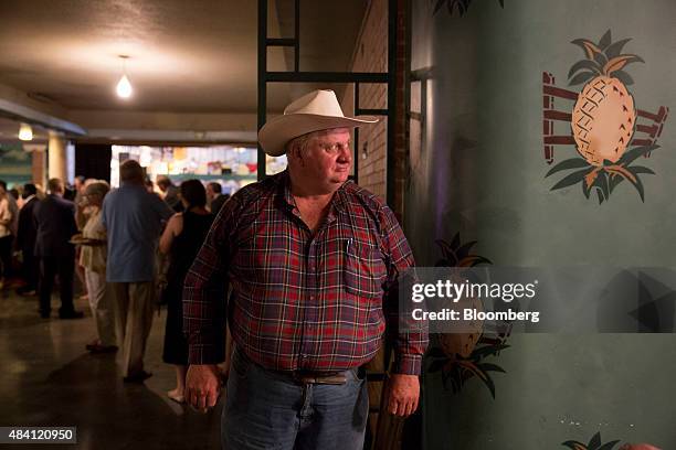 An attendee watches as guests arrive for the Democratic Wing Ding in Clear Lake, Iowa, U.S., on Friday, Aug. 14, 2015. The event, first held in 2004,...