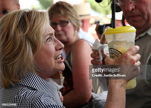 Democratic presidential hopeful and former Secretary of State Hillary Clinton holds a lemonade as she tours the Iowa State Fair on August 15, 2015 in...