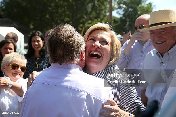 Democratic presidential hopeful and former Secretary of State Hillary Clinton hugs a friend while touring the Iowa State Fair on August 15, 2015 in...