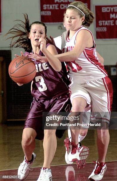 Staff Photo by Doug Jones, Monday, January 19, 2004: Laurie Fortier of Noble attempts to shield the ball from Lindsey Coit of South Portland during...