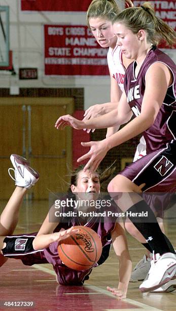 Staff Photo by Doug Jones, Monday, January 19, 2004: Noble's ,#3, Laurie Fortier, goes to the floor after being tripped. South Portland's Tricia...
