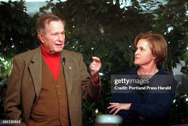 Staff photo by Gregory Rec -- Doro Bush Koch watches her father George H.W. Bush as he answers a question from the audience during a book signing at...