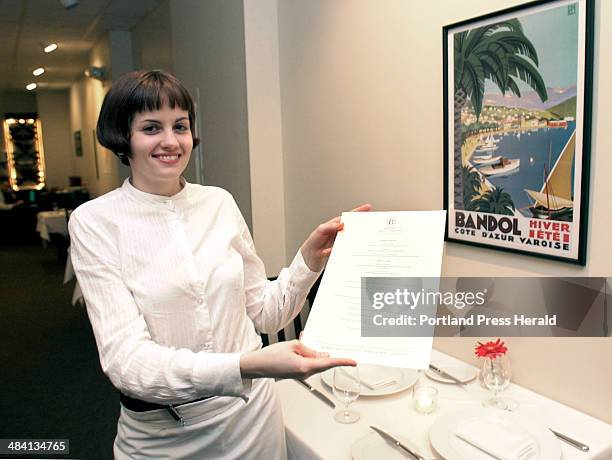 Staff Photo by John Patriquin, Wednesday, November 12, 2003: Lavender Marsh displays a menu at Bandol restaurant on Exchange st. In Portland.