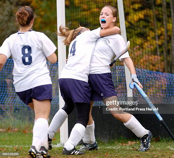 Staff Photo by Derek Davis: Westbrook's Erin Murphy, right, is mobbed by teammates Erin Knott and Julia Cuddy, left, after scoring unassisted and...