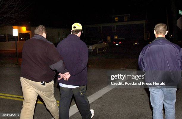 Staff Photo by John Patriquin, Monday, November 10, 2003: Probation officers Marc Montminy and Scott Landry lead a probationer off to the Cumberland...