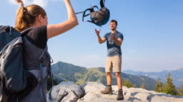 Woman Throwing Backpack To Man In Mountains High-Res Stock Video Footage -  Getty Images