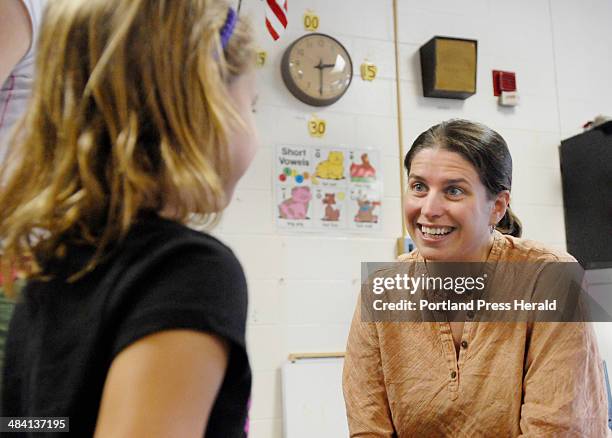 Staff photo by John Ewing: Wednesday, August 30, 2006 -- .Emily Wright, a first grade teacher at Freeport's Morse Street School greets incoming...