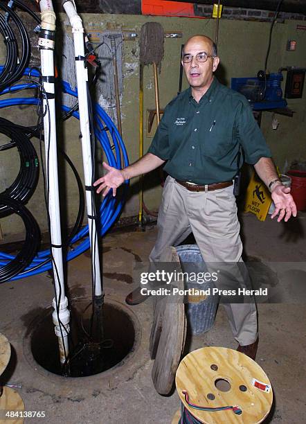 Staff Photo by John Patriquin. Wed. 8/23/06. Rich Pfirman, owner of Tilson True Value Hardware in Dexter, shows the sump pump in the basement of the...