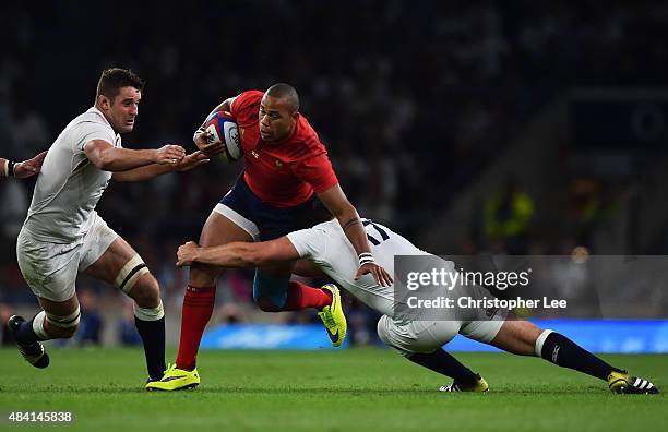 Gael Fickou of France is tackled by Alex Corbisiero and Calum Clark of England during the QBE International match between England and France at...