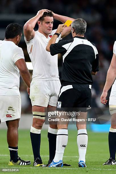 Referee John Lacey of Ireland shows the yellow card to Calum Clark of England during the QBE International match between England and France at...